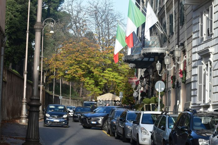 A bunch of cars parked on the side of a street