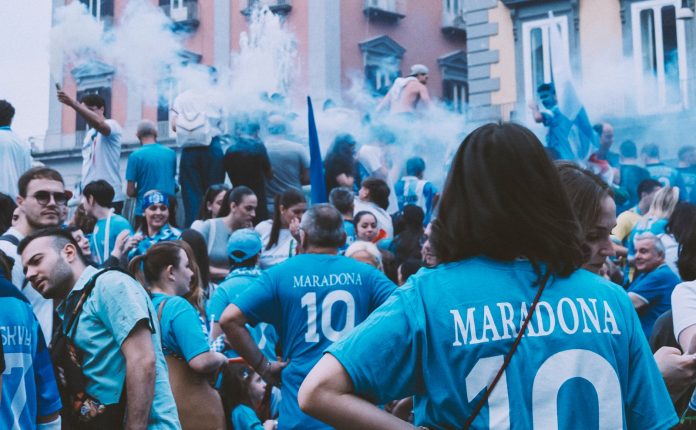 a group of people standing around each other